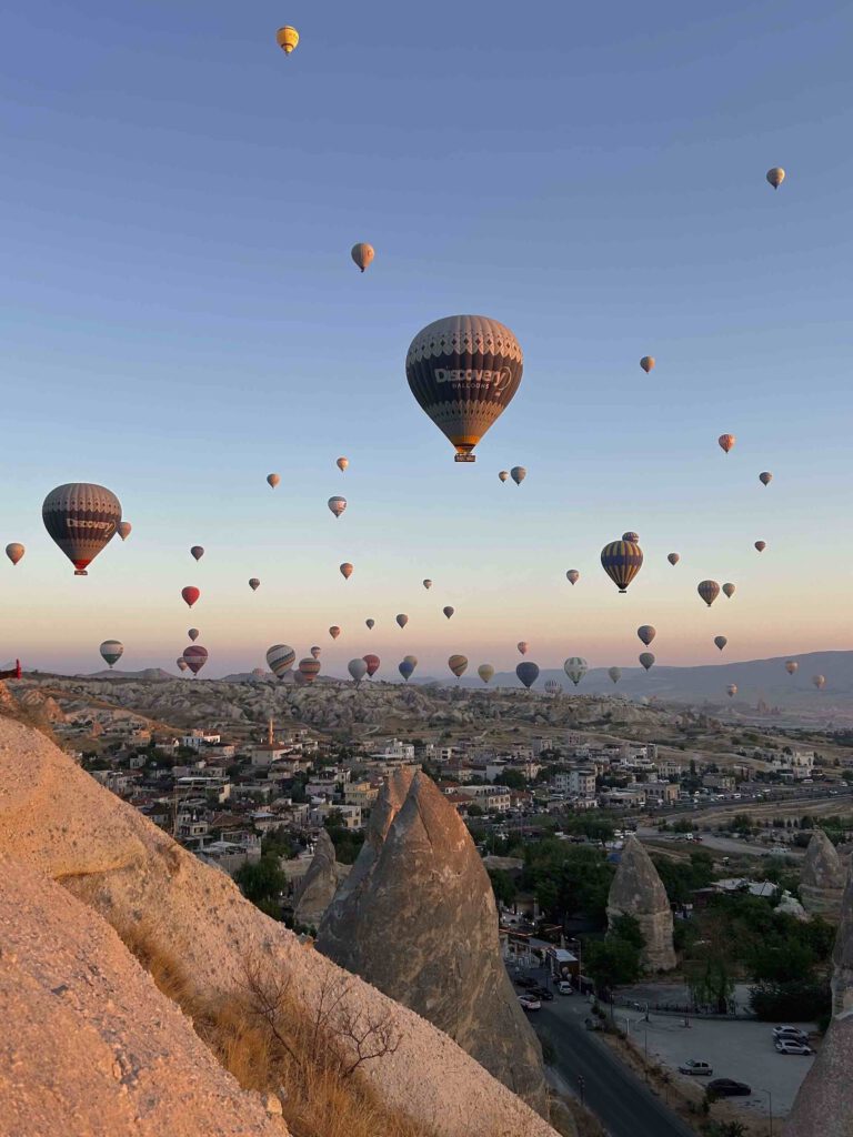 Many hot air balloons above a mountain in Cappadocia Turkey at sunrise