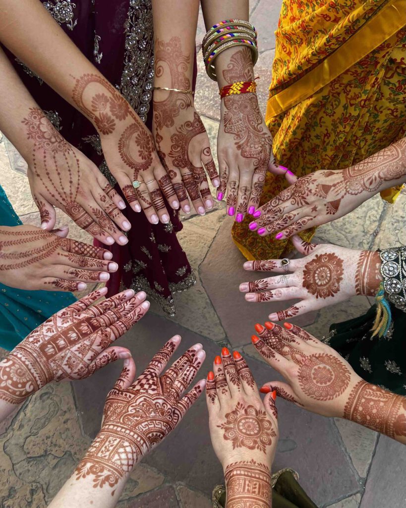 A tour group's hands painted with Indian henna connected together in a circle