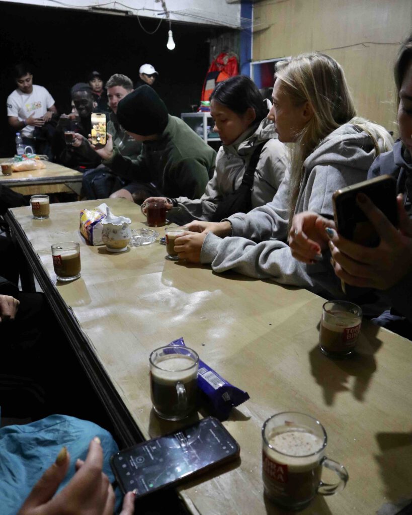 East Java tour group waiting for Mount Bromo sunrise in a warming hut in Indonesia