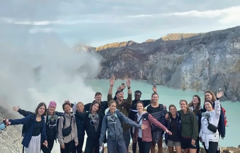 Aerial view of the turquoise sulphuric crater lake inside Mount Ijen East Java Indonesia with Mador Hostel tour group