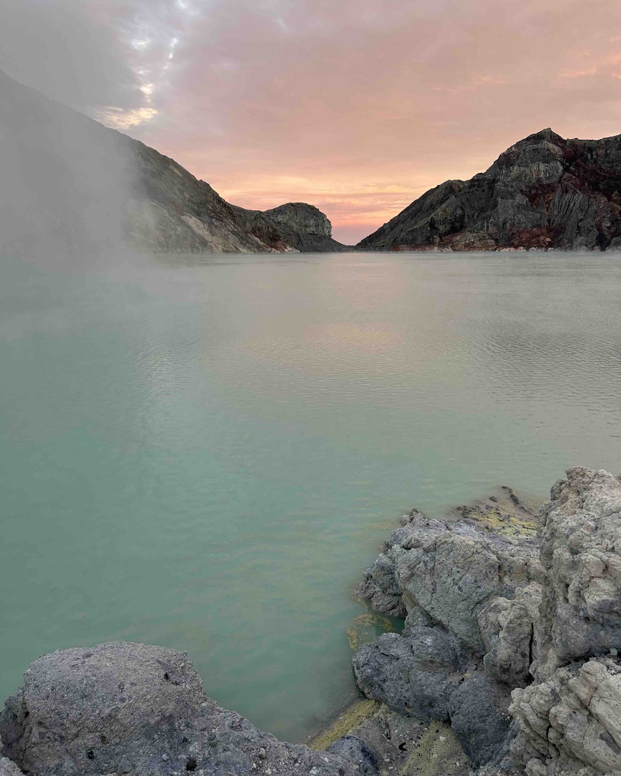 Turquoise crater lake at Mount Ijen at sunrise East Java Indonesia