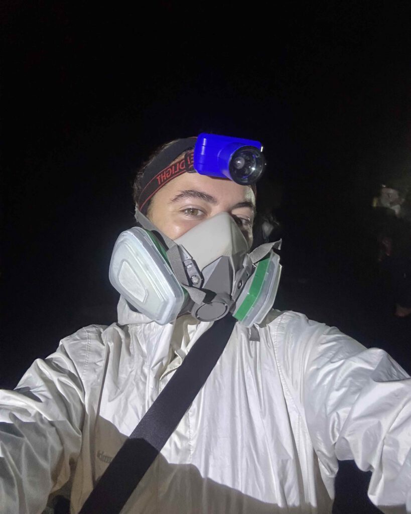 Solo female traveller wearing gas mask inside Mount Ijen crater East Java Indonesia
