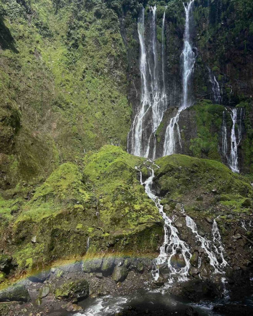 Tumpak Sewu waterfall surrounded by lush jungle in East Java Indonesia
