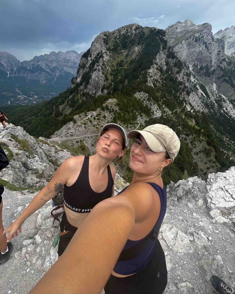 Wanderers Hostel travellers reaching the summit of the Valbona to Theth hike