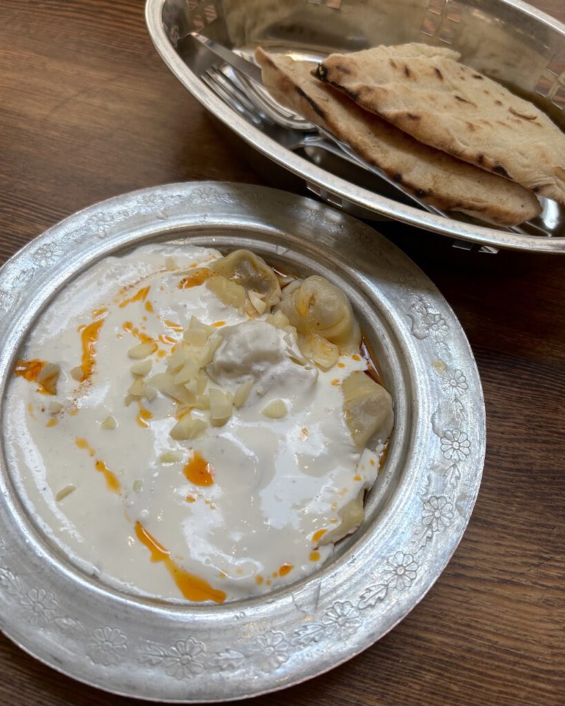 Traditional Bosnian klepe with garlic yogurt sauce