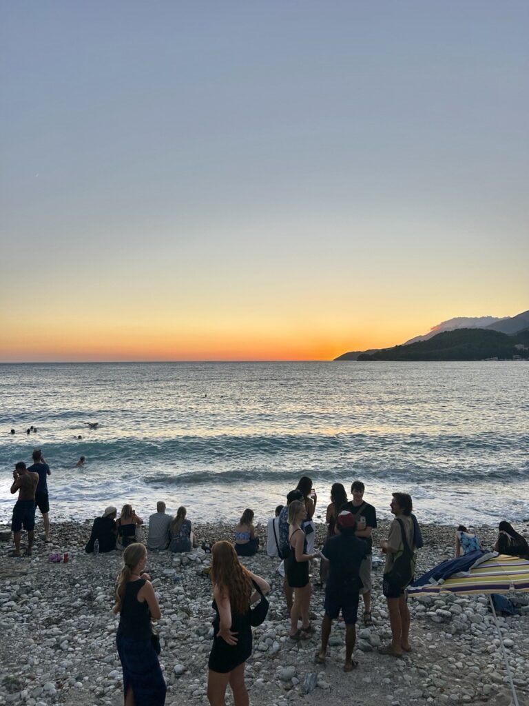 Watching sunset with fellow backpackers in Himarë at Trip'n'Hostel Seaside