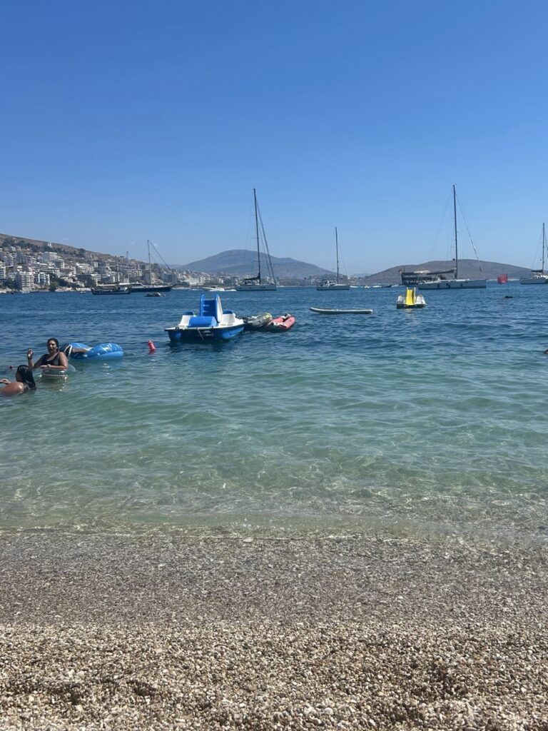 Swimmers and boats near Sarandë, Albania